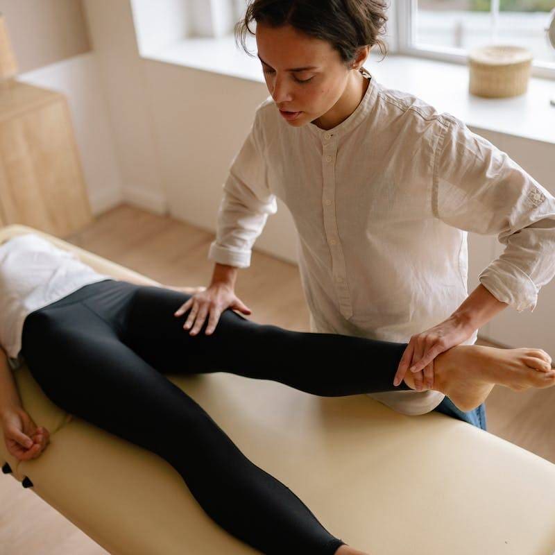 Physiotherapist Holding Womans Leg