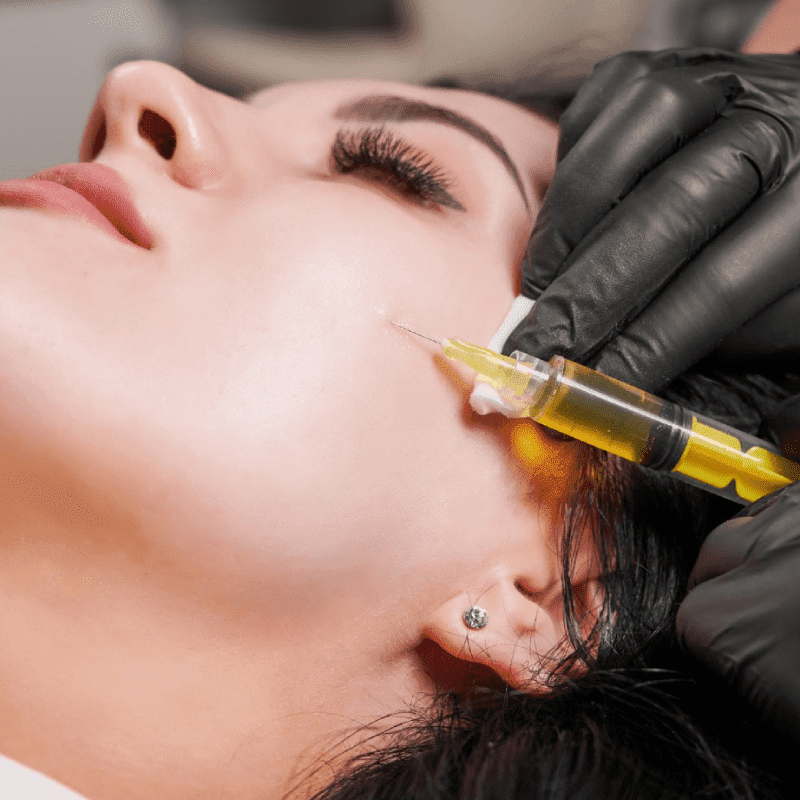 female doctor making injection woman chin